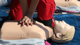 Cardiopulmonary resuscitation (CPR) training demonstration showing paramedic performing chest compressions on adult CPR dummy during first aid course - Powered by Shutterstock - Get 15% off with code: PIKWIZARD15