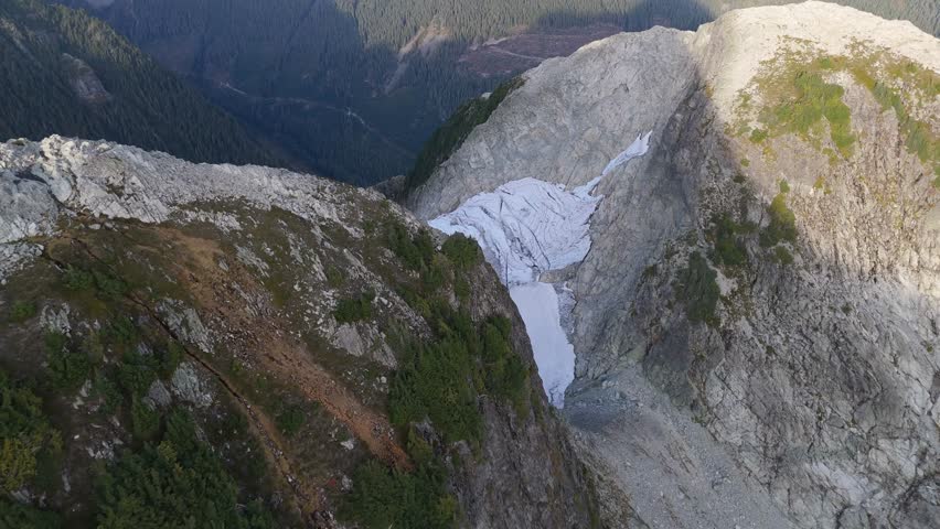 Aerial View of a Massive Glacier Nestled Between Majestic Mountains in British Columbia, Canada