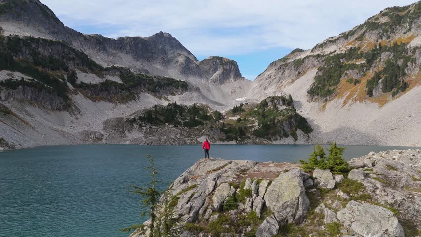 Hiker Enjoying Majestic Turquoise Mountain Lake View in British Columbia, Canada