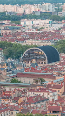 Aerial timelapse of Hotel de Ville de Lyon day to night transition, the historic city hall of Lyon, France. Historic center with red roofs from above. A baroque and classical architectural marvel