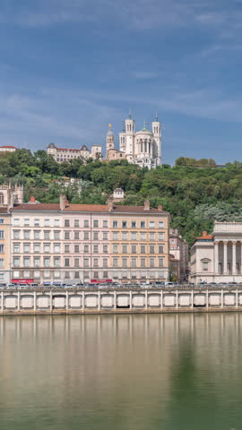 Timelapse hyperlapse of the Lyon Court of Appeal, a neo-classical courthouse at Place Duquaire in Lyon's 5th arrondissement. Scenic views of the Saone waterfront and red suspension footbridge. France.