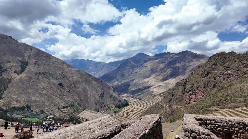 Pisac, Peru: Panoramic footage of famous agriculture terraces ruins in sacred valley region near Cusco under blue sky and with mountains in the background