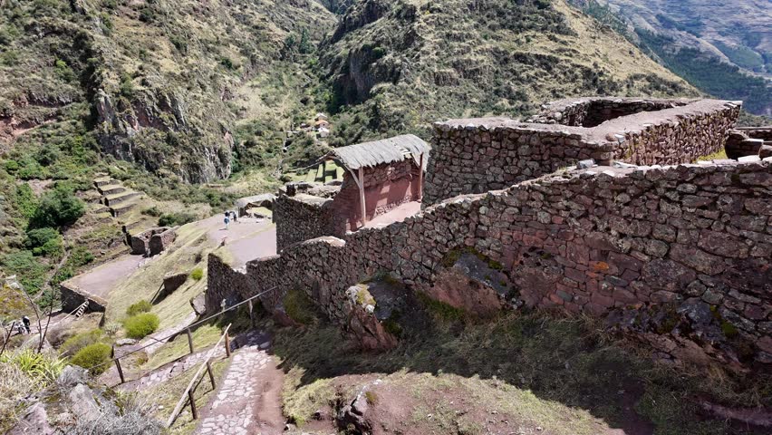 Huaraz, Peru: Panoramic footage of Inca ruins in sacred valley near Pisac, Peru. An archeological site located on hilltop surrounded by mountains