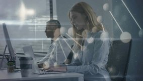 Business colleagues typing on laptop and desktop in office, causing live data overlays animating. Technology, innovation, collaboration, modern, productivity, analysis, digital - Powered by Shutterstock - Get 15% off with code: PIKWIZARD15