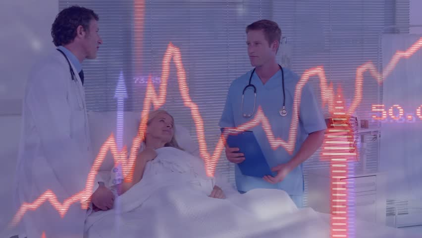 Patient raising hand talking as team adjusting IV reviewing chart with vitals graph planning care. Medical, healthcare, clinical, hospital, treatment, professionalism, patientcare