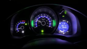 Close-up POV of an illuminated car instrument cluster at night, showing speedometer, tachometer, and gauge lights while driving. Generic transportation concept. No logos, no people. - Powered by Shutterstock - Get 15% off with code: PIKWIZARD15