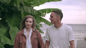 young romantic couple walking hand in hand, talking. in slow motion during the daytime - Powered by Shutterstock - Get 15% off with code: PIKWIZARD15