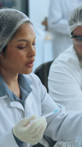 Scientist, woman or pipette with test tube in lab for biology experiment, stem cell research or pathology. Science, person and drop chemical solution for chemistry, healthcare and medical innovation.