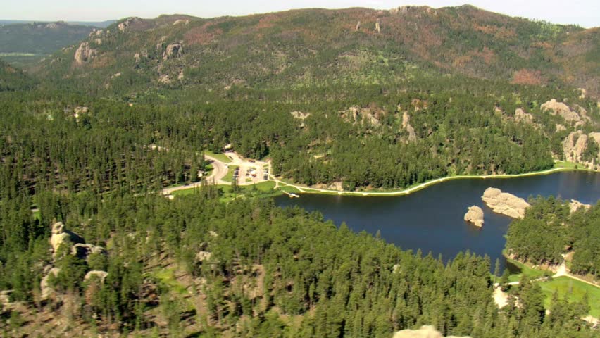 Aerial view of Sylvan Lake surrounded by rock formations and lush green forest