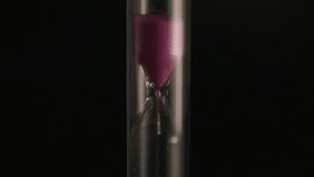 Macro video of purple sand trickling through a glass hourglass on a dark background. Elegant minimalist concept symbolizing time, patience, and mindfulness. Ideal for meditation visuals, design projec - Powered by Shutterstock - Get 15% off with code: PIKWIZARD15
