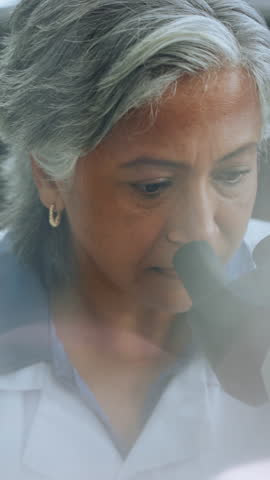 Mature woman, microscope and scientist with research for experiment, study and cure development. Science, microbiology equipment and person in laboratory for medical innovation, analysis and test