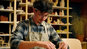 Caucasian man guy male sculptor potter art designer architect decorator craftsman holding measuring instrument working on table pottery workshop ceramics design craft handmade painting measure draft - Powered by Shutterstock - Get 15% off with code: PIKWIZARD15