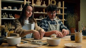 Caucasian family smiling girl guy couple date in pottery workshop handmade master class woman potter sculptor artist teaching student man modeling clay together hobby craft stoneware in art studio - Powered by Shutterstock - Get 15% off with code: PIKWIZARD15