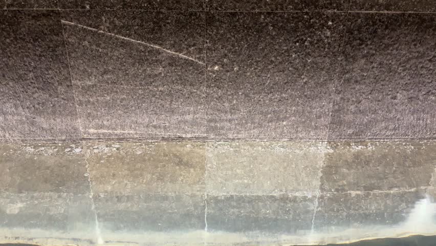 4k footage, close up cascading waterfall fountain on a slate stone. Seen here the water fountain droplets dropping, landscape garden design. Contemporary modern garden design waterfall.