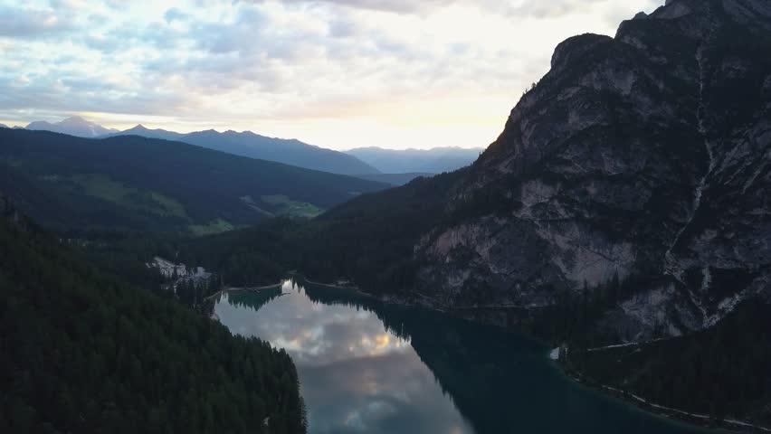 Aerial view of Braes Lake reflecting mountains at sunset