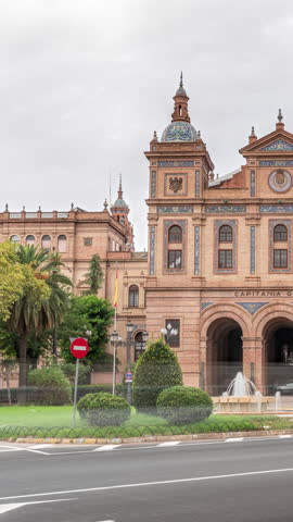 Facade of the General Captaincy of II Military Region in Seville, Spain. Headquarters of the Army Land Forces in Andalusia. Timelapse hyperlapse with traffic, cloudy sky and green trees.