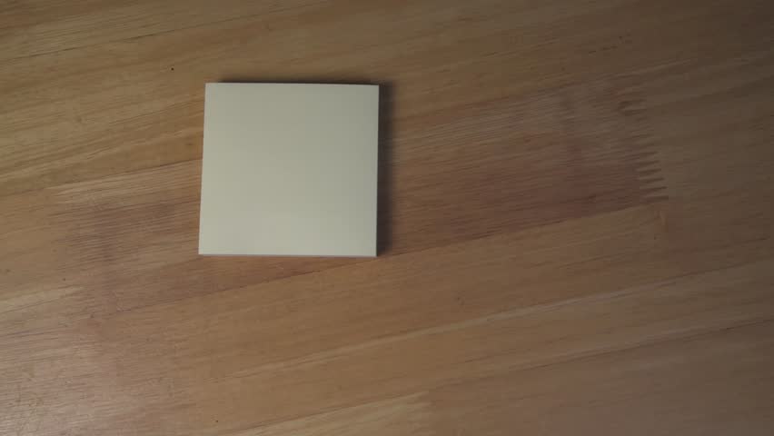 Close-up video of hands writing “I love you X” on a yellow Post-It note. Ideal for romance, love, relationships, and heartfelt concept themes.