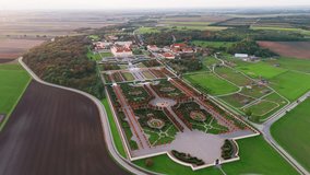 Aerial view of Schloss Hof Castle at sunset in Marchfeld, Austria. Majestic Baroque palace surrounded by beautifully landscaped formal gardens, a fine example of classical European architecture. - Powered by Shutterstock - Get 15% off with code: PIKWIZARD15