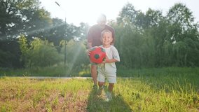 Father and son, child and boy, father and son, child and boy, soccer ball, football game, soccer ball, football game in sunshine, running on grass, sharing joy, fun sports and bonding moments. - Powered by Shutterstock - Get 15% off with code: PIKWIZARD15