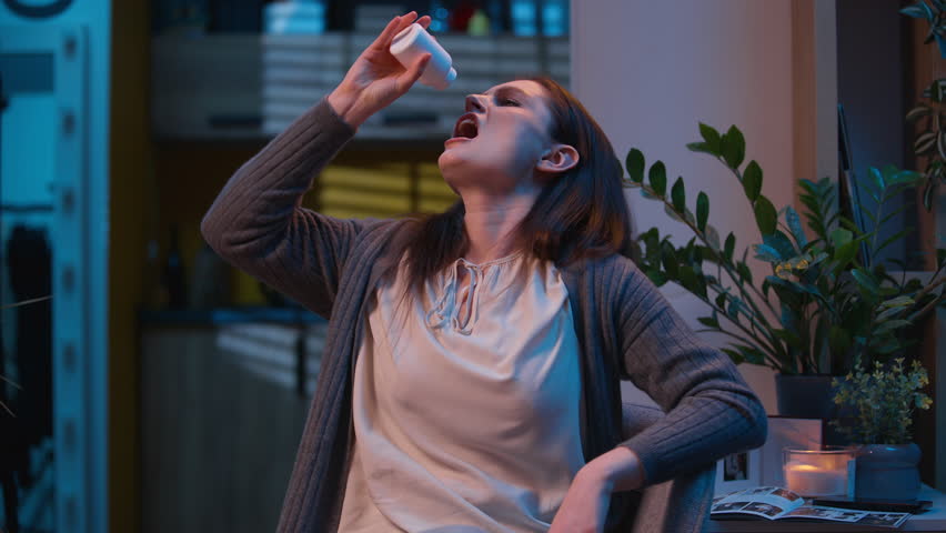 Stressed woman girl sad at night home drink pills drugs medicine health care medication painkiller antidepressant therapy stress unwell sick female addicted tablets dose insomnia empty bottle upset