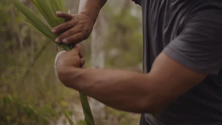 Close-Up of Person Weaving Palm Leaves in 4K Ultra HD — Hands Crafting Traditional Basket or Mat from Natural Palm Leaves, Highlighting Artisanal Skill, Craftsmanship, and Cultural Heritage