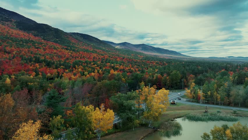 Adirondack Mountain, New York State. Aerial view of autumnal landscape with mountain range and road amidst forested area during autumn season.