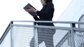 Businesswoman standing outside airplane using digital tablet before flight. - Powered by Shutterstock - Get 15% off with code: PIKWIZARD15