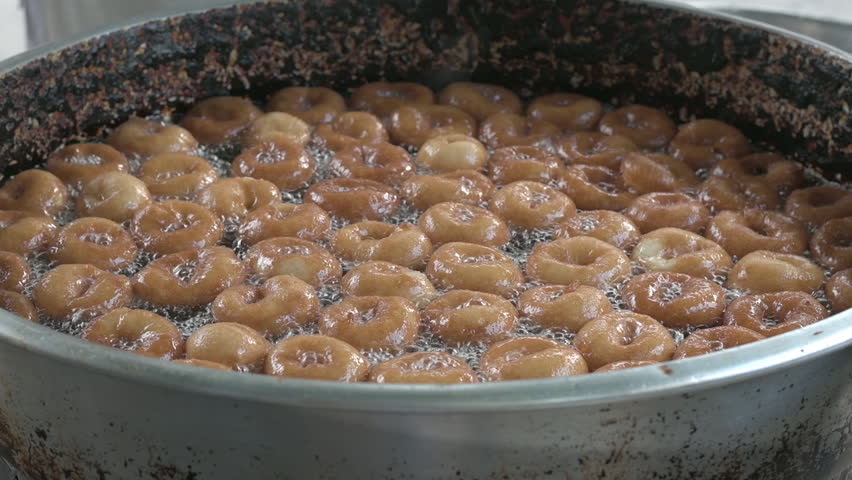Traditional Turkish dessert. It is called "Lokma". Delicious and authentic street food. Special for Ramadan. Chef is preparing Lokma desserts to eat for people.
