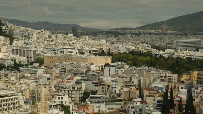 View the bustling streets of Athens with its mix of modern and classic architecture. High-rise buildings and lush greenery make this city an exciting place to explore.