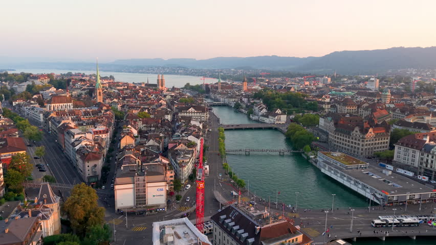 Aerial view of Zurich Cityscape at sunrise, showcasing architecture and city life. Switzerland