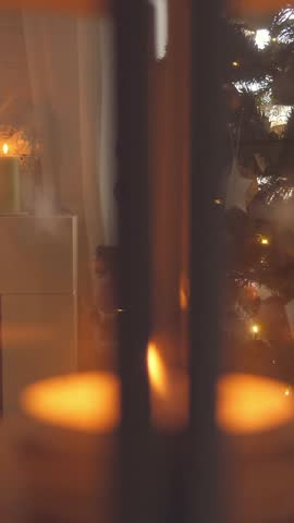 Christmas celebration in cozy interior with decorated spruce tree and merino plaid. Winter holidays. Vertical footage