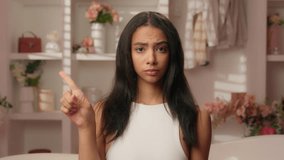 Hispanic serious dissatisfied woman ethnic beautiful girl displeased female forbid waving finger shaking no gesture reject deny disagree in home bathroom cosmetology beauty warn acne skin treatment - Powered by Shutterstock - Get 15% off with code: PIKWIZARD15