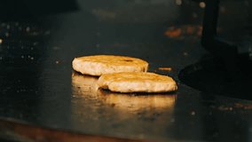 A chef's black-gloved hand places cheese on a grilled burger patty. Street food preparation - Powered by Shutterstock - Get 15% off with code: PIKWIZARD15
