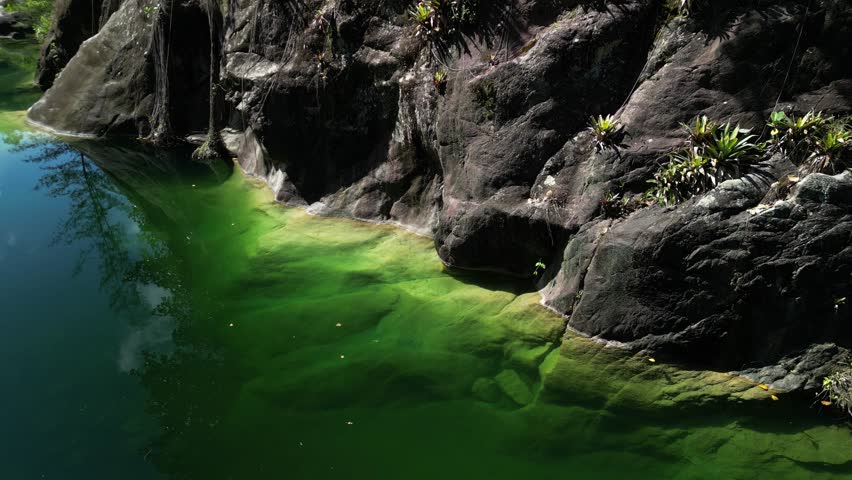 Aerial panoramic of Dos Aguas showing full width of waterway, surrounding jungle, and bright daylight. Ideal for establishing shots in travel films