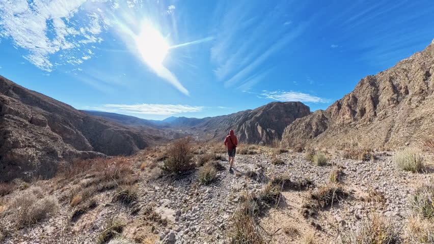 Following Man Down Rocky Desert Hill in Big Bend