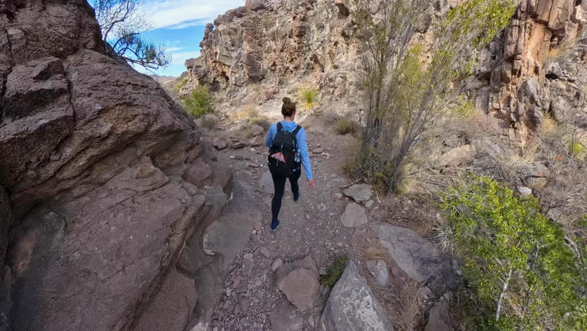 Following Woman Dropping Into Wash in Big Bend National Park