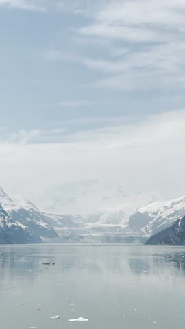 Scenic view of Glacier Bay, Alaska — majestic glaciers, calm turquoise waters, and snow-capped mountains in a serene icy landscape.