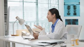 Asian female doctor doing online consultation, remote healthcare, virtual medical advice to patient via video call in hospital or clinic. Telemedicine, digital healthcare services, online diagnosis. - Powered by Shutterstock - Get 15% off with code: PIKWIZARD15