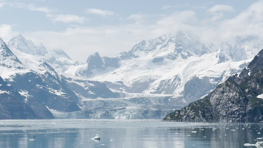 Scenic view of Glacier Bay, Alaska — majestic glaciers, calm turquoise waters, and snow-capped mountains in a serene icy landscape.
