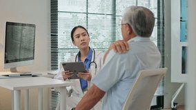Asian female doctor discussing symptoms, health consulting senior elderly male patient in clinic, using digital tablet to record and analyze medical data. Modern healthcare with integrated technology. - Powered by Shutterstock - Get 15% off with code: PIKWIZARD15