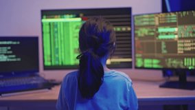 Young person analyzing data on multiple screens in a dimly lit room, focused on code and analytics, representing modern technology and programming skills - Powered by Shutterstock - Get 15% off with code: PIKWIZARD15