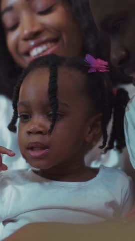 A girl with braids and a woman share a joyful moment together