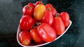 A bowl full of home grown plum tomatoes ready to eat - Powered by Shutterstock - Get 15% off with code: PIKWIZARD15