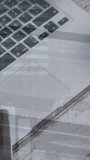 Animation of statistical data processing against laptop, smartphone and glasses on wooden table. Business data technology concept - Powered by Shutterstock - Get 15% off with code: PIKWIZARD15