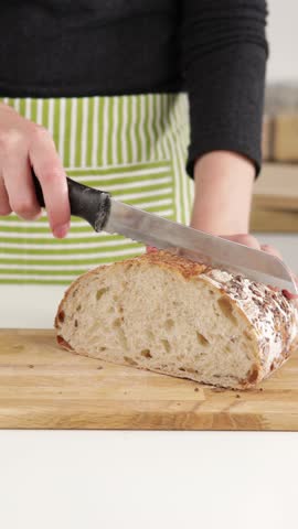 slicing sour dough bread with knife