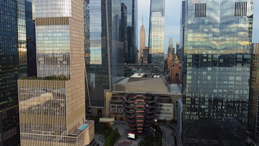 Aerial view backwards in front of high-rise in Hudson Yards, sunset in New York