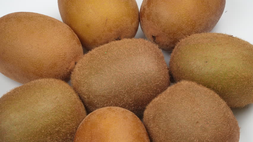 A pile of fresh, whole kiwi fruits spinning 360 degrees. Isolated on a white background. Studio shot for healthy food, Vitamin C, or diet concepts.
