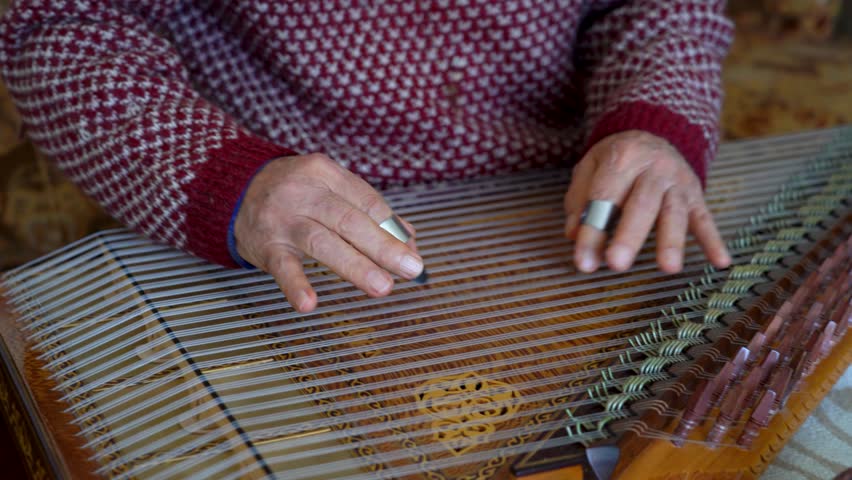 old man playing qanun, traditional turkish instrument, kanun, turkish man performing wooden string instrument