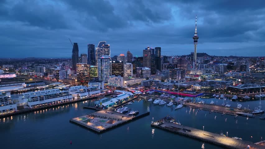 Panorama Flight through Auckland , New Zealand. Skyline. New Skyscrapers. Urban Canyon in Night Light. Aerial Pedestal in Establishing Night Drone Shot. Glowing street lights 