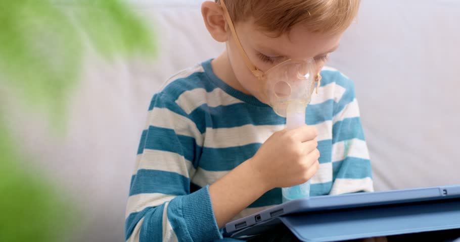Child Using Nebulizer While Engaging with Tablet at Home
